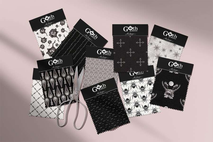 A collection of black and white Gothic fabric swatches and scissors on a shaded pink background.