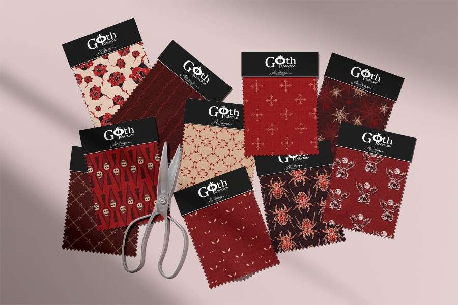 A collection of red Gothic fabric swatches and scissors on a shaded pink background.
