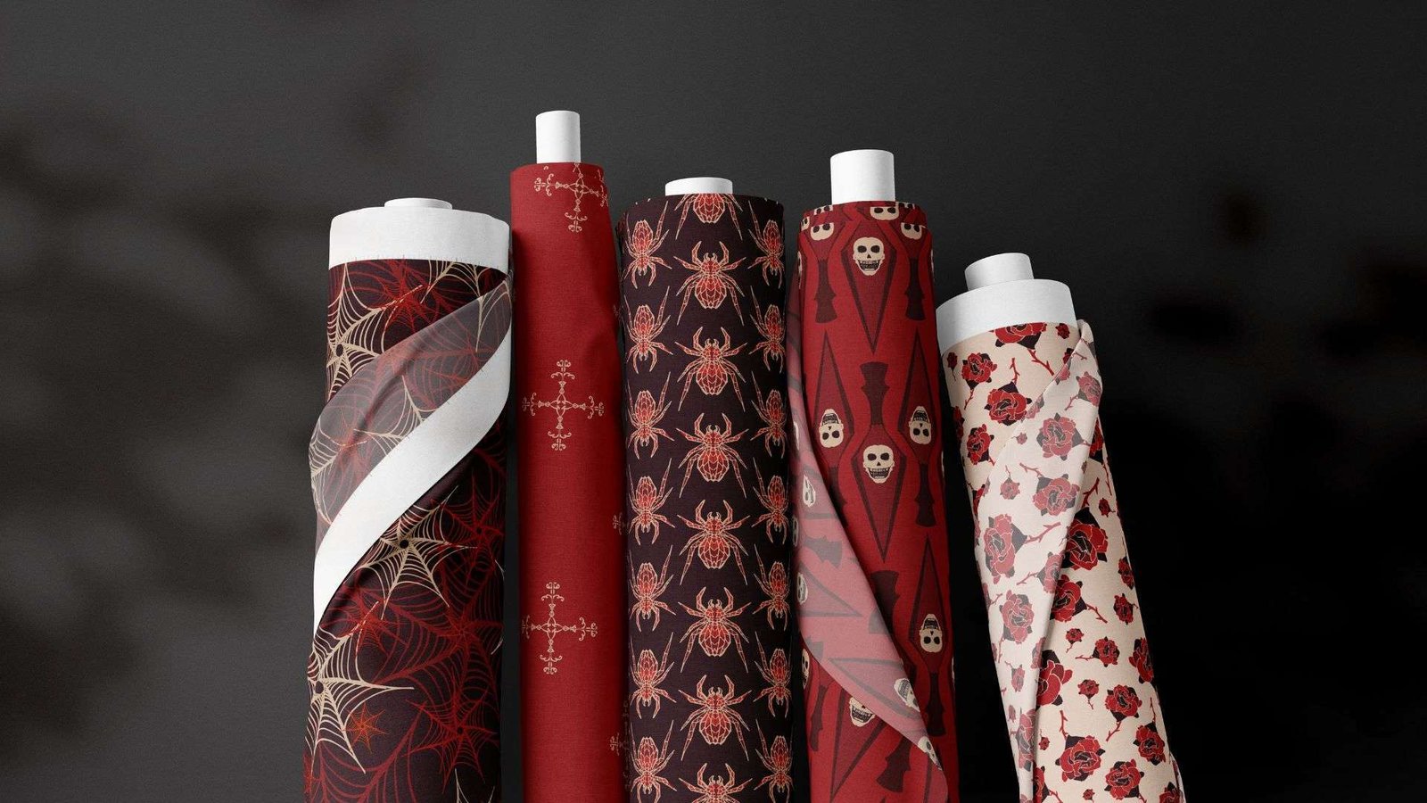 A group of red and black patterned paper rolls on a black background.