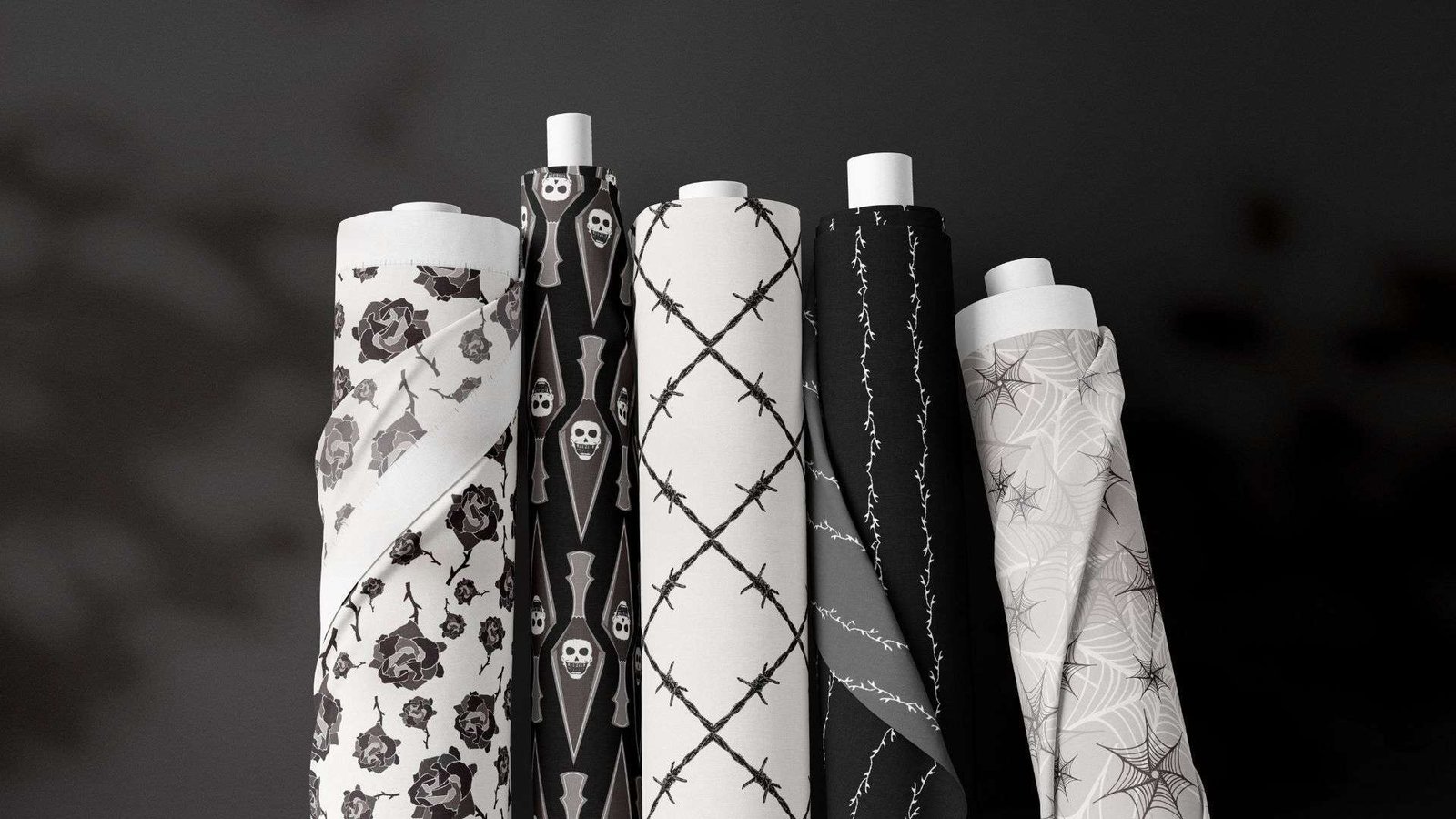 A group of red and black patterned paper rolls on a black background.